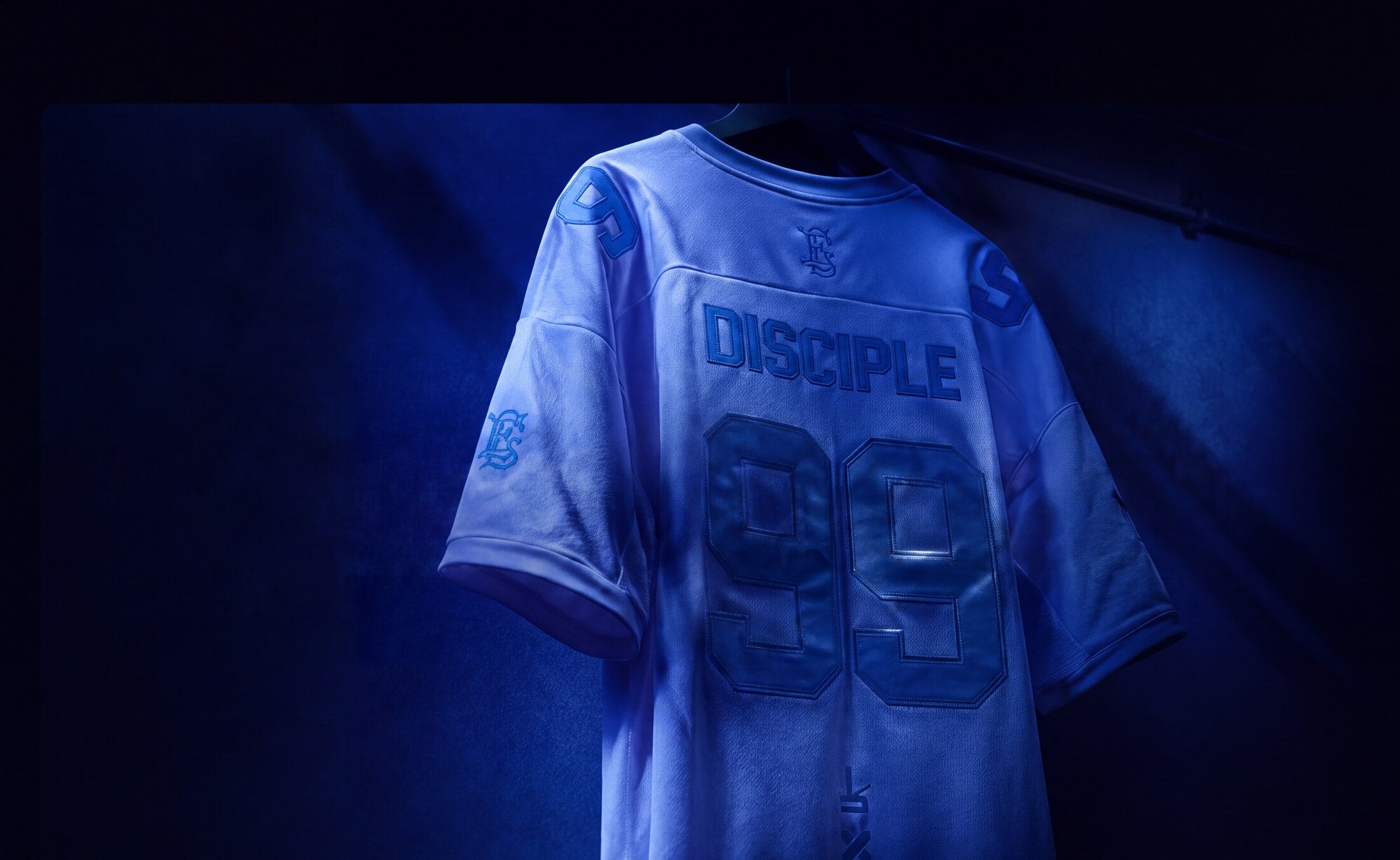 The DISCIPLE 99 jersey, hanging in blue light