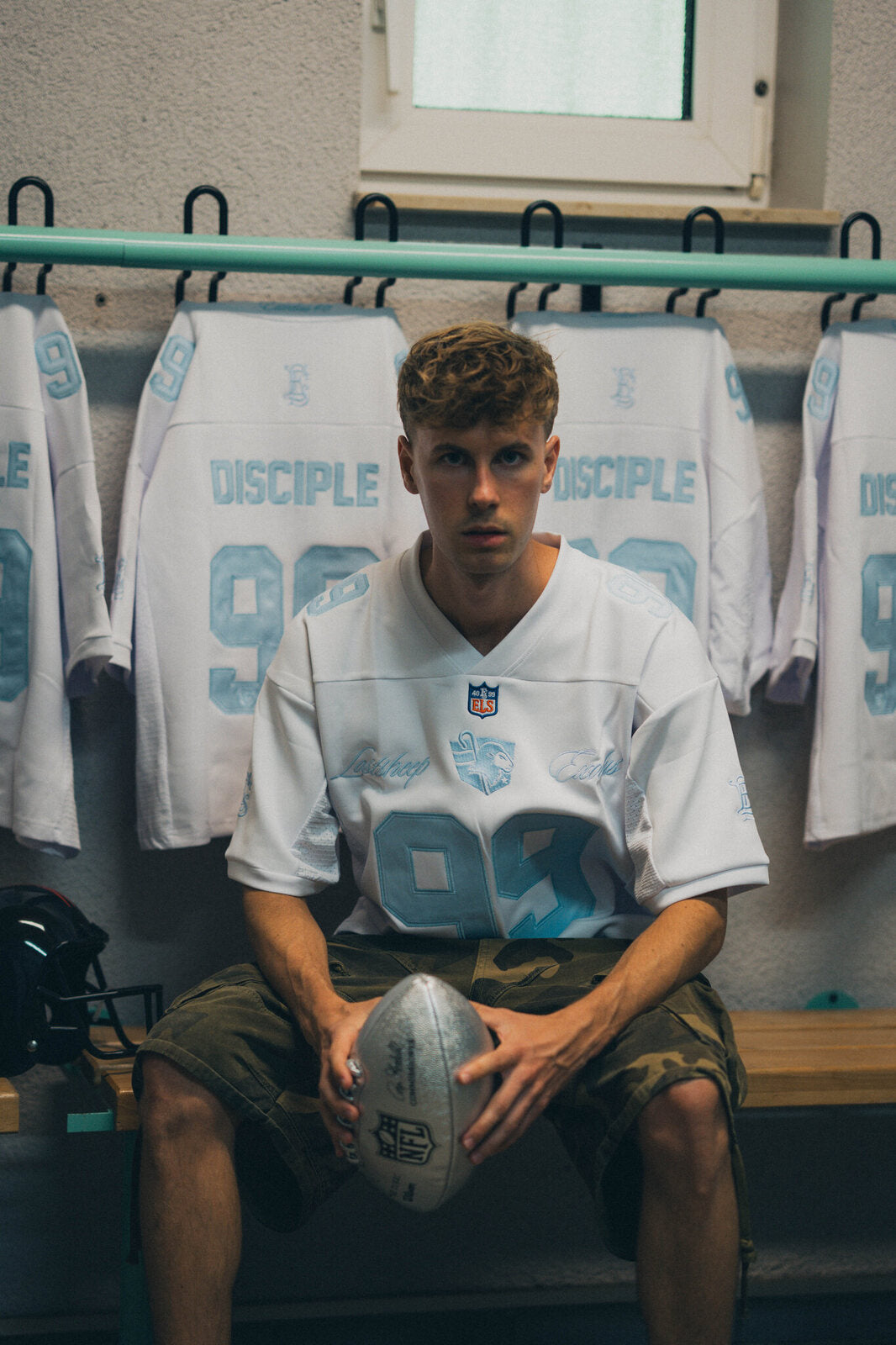 DISCIPLE 99 jersey, model in the locker room with a football